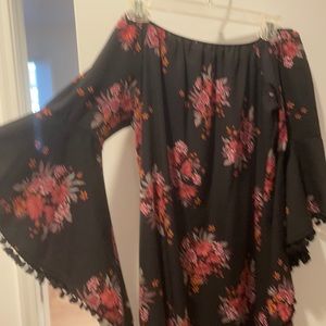 Off the shoulder black dress with red flower detailing